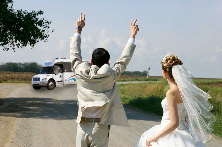 Bride and Groom celebrating the arrival of a Badder Wedding Bus
