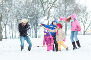 Family_Day_showing_four_children_throwing_snowballs_at_their_parent